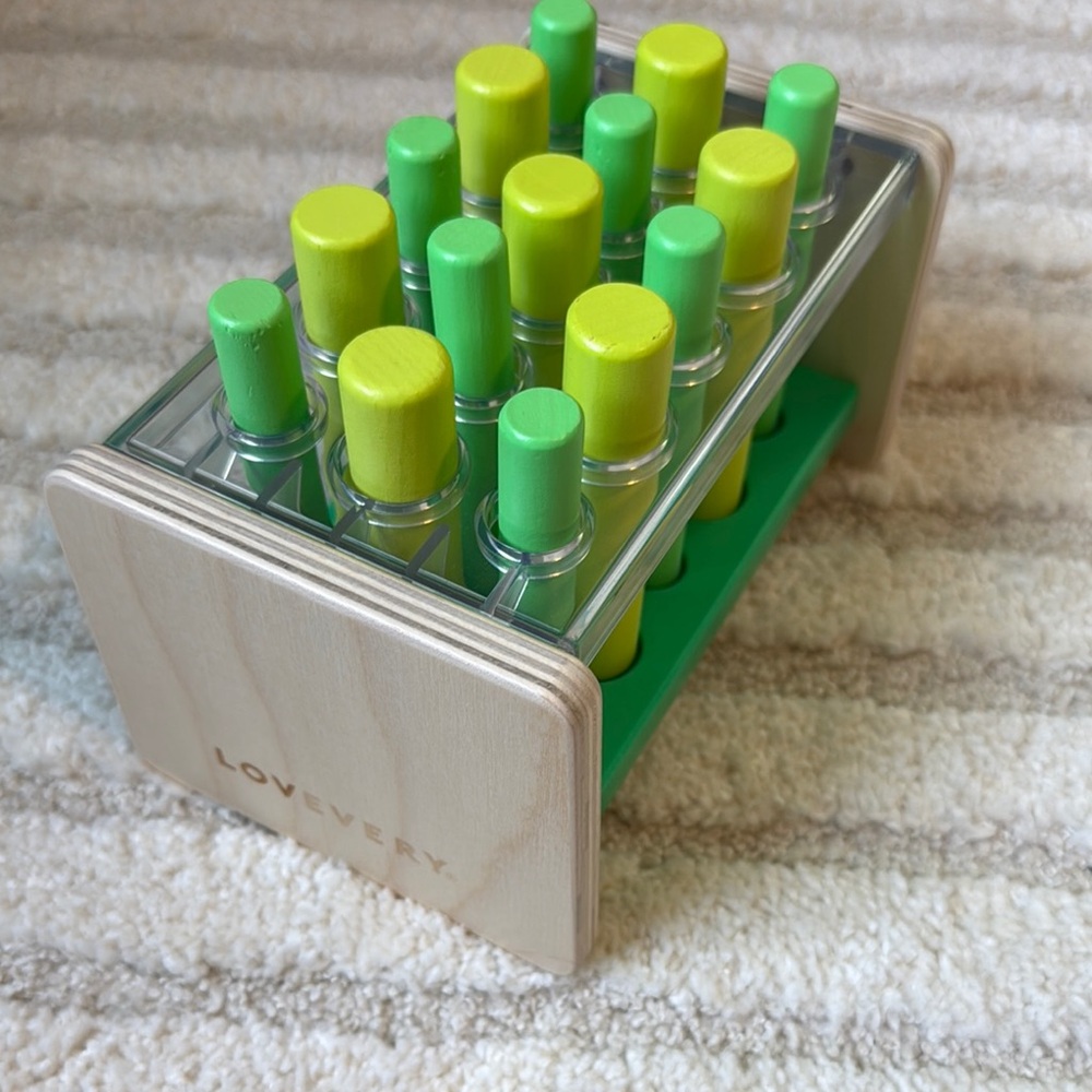 Lovevery Wooden Peg Toy with Green and Yellow Pegs